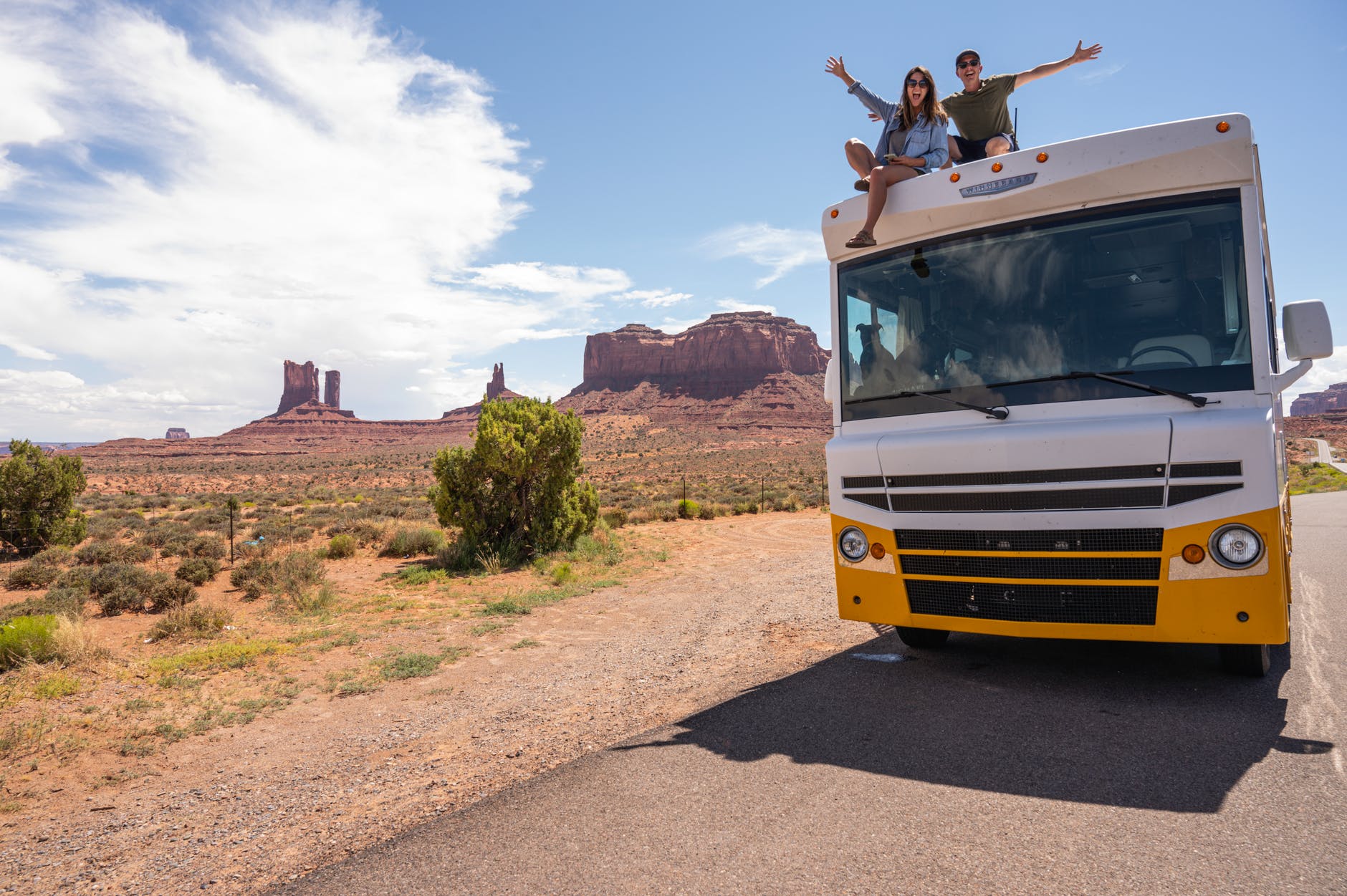 couple sitting on top of the rv