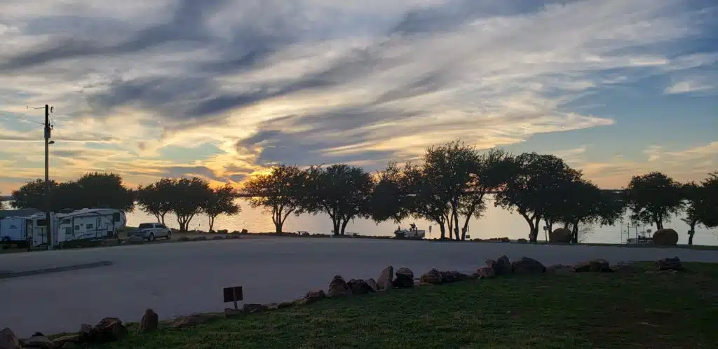 Extended Stays 3 Lake Buchanan RV & Cabin Resort Boat ramp at sunset with trees