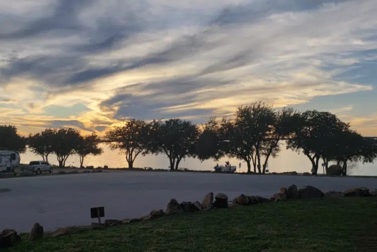 Extended Stays 9 Lake Buchanan RV & Cabin Resort Boat ramp at sunset with trees